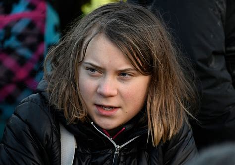 Police officers take Swedish climate activist Greta Thunberg away from the edge of the Garzweiler II opencast lignite mine during a protest action by climate activists after the clearance of ...